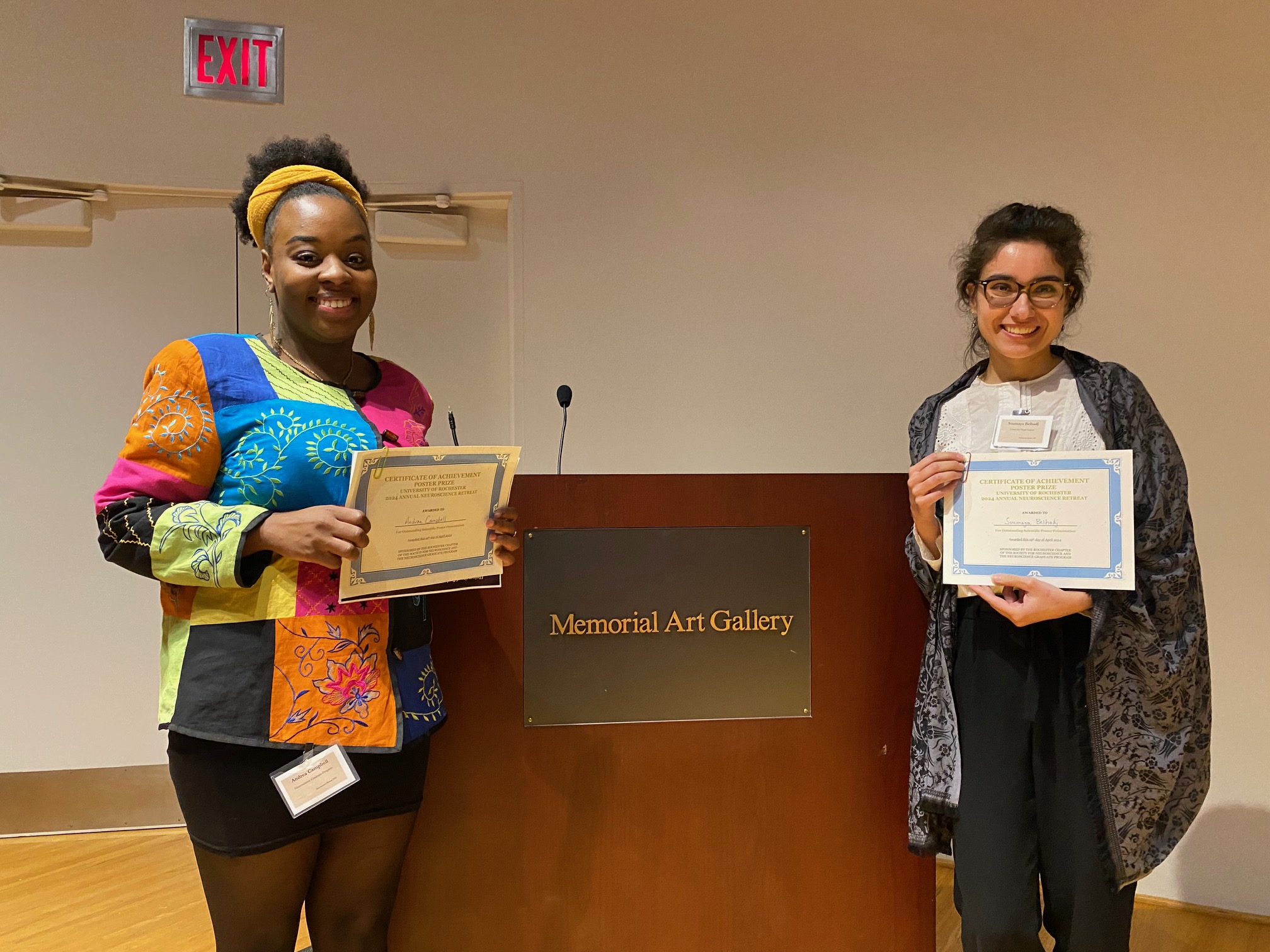 Soumaya BelHadj and Andrea Campbell holding up their award certificates at the Neuroscience retreat.